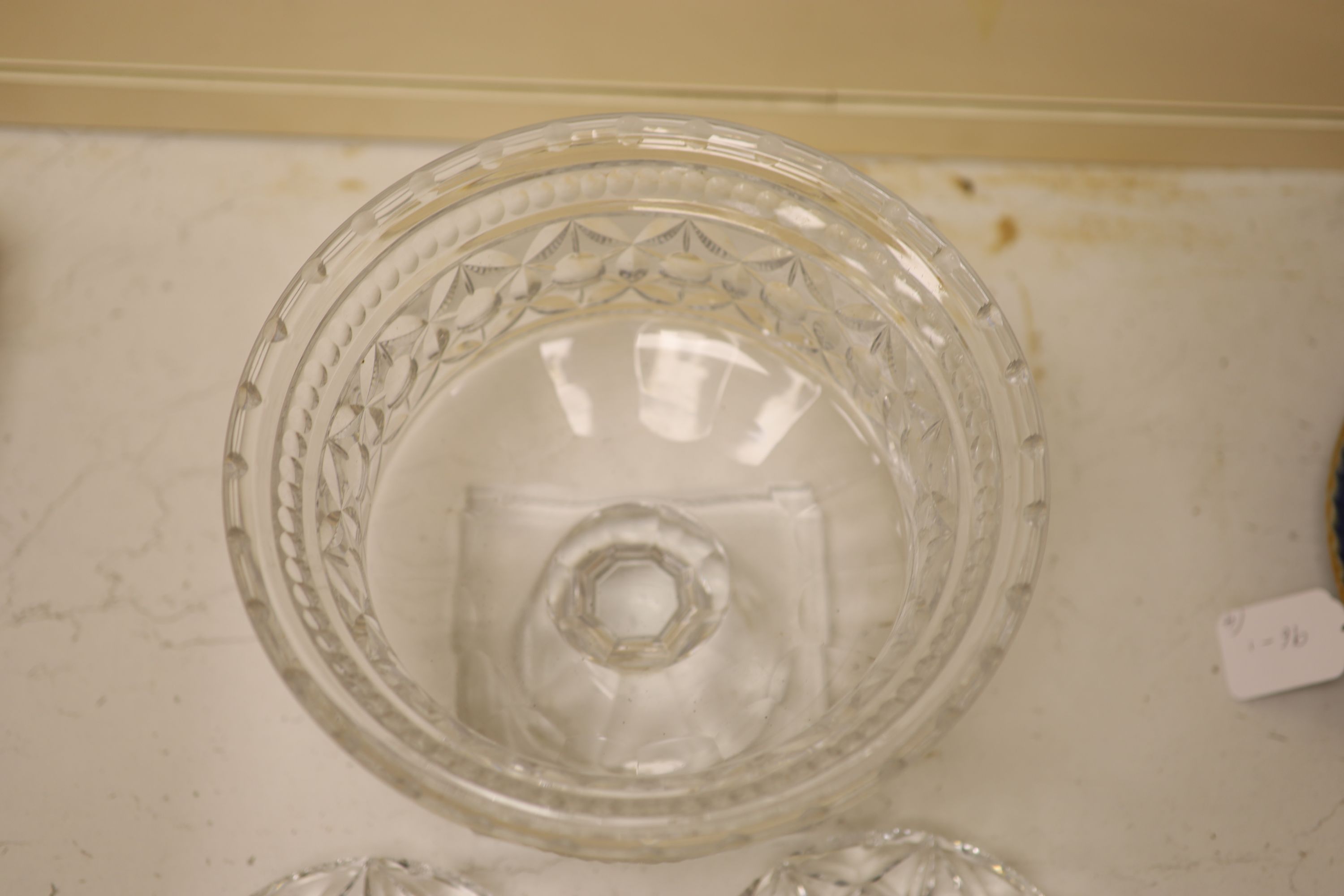 A large and heavy clear cut glass pedestal bowl, 20cm high, and two finger bowls